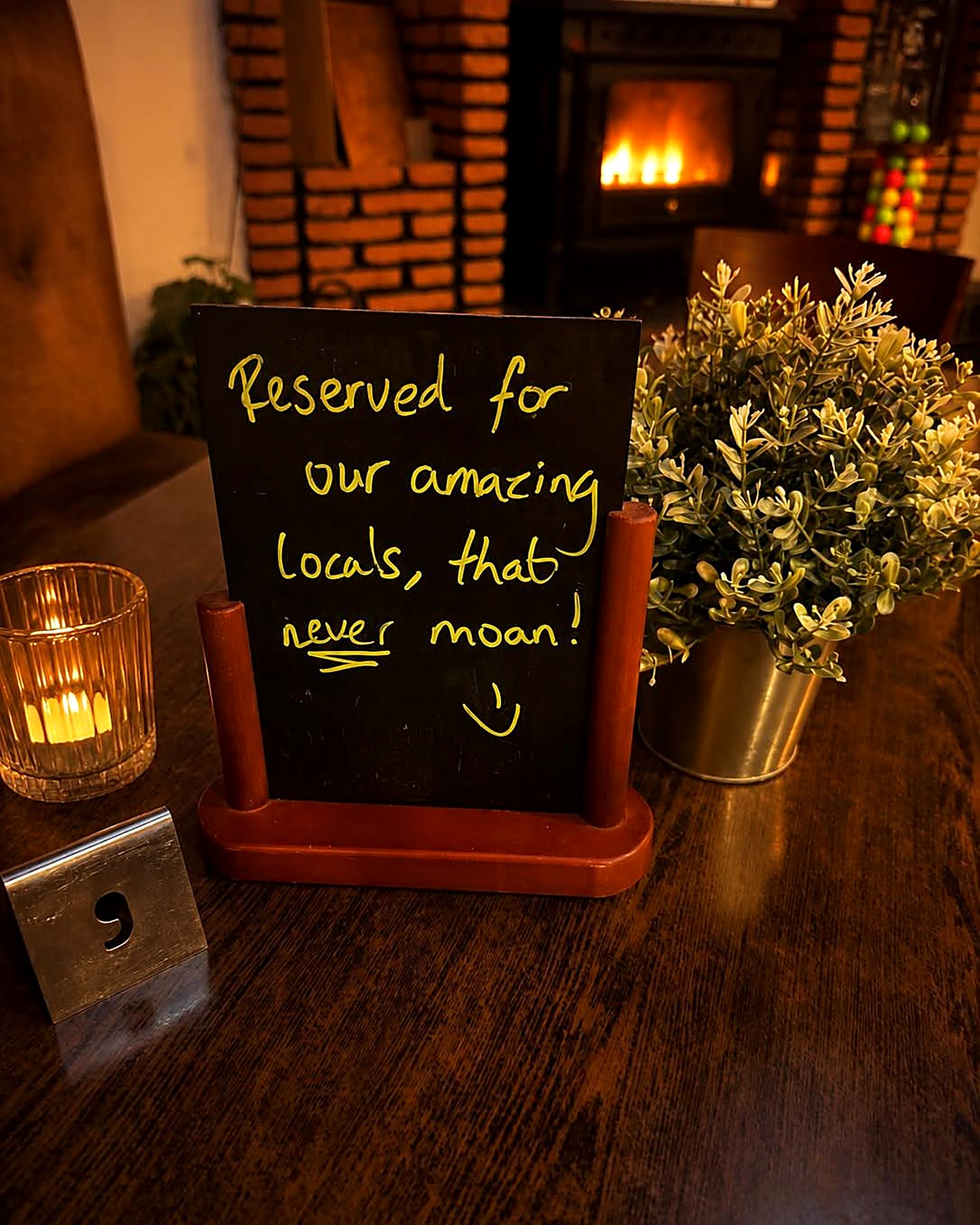Cosy fireside corner with the locals chalkboard