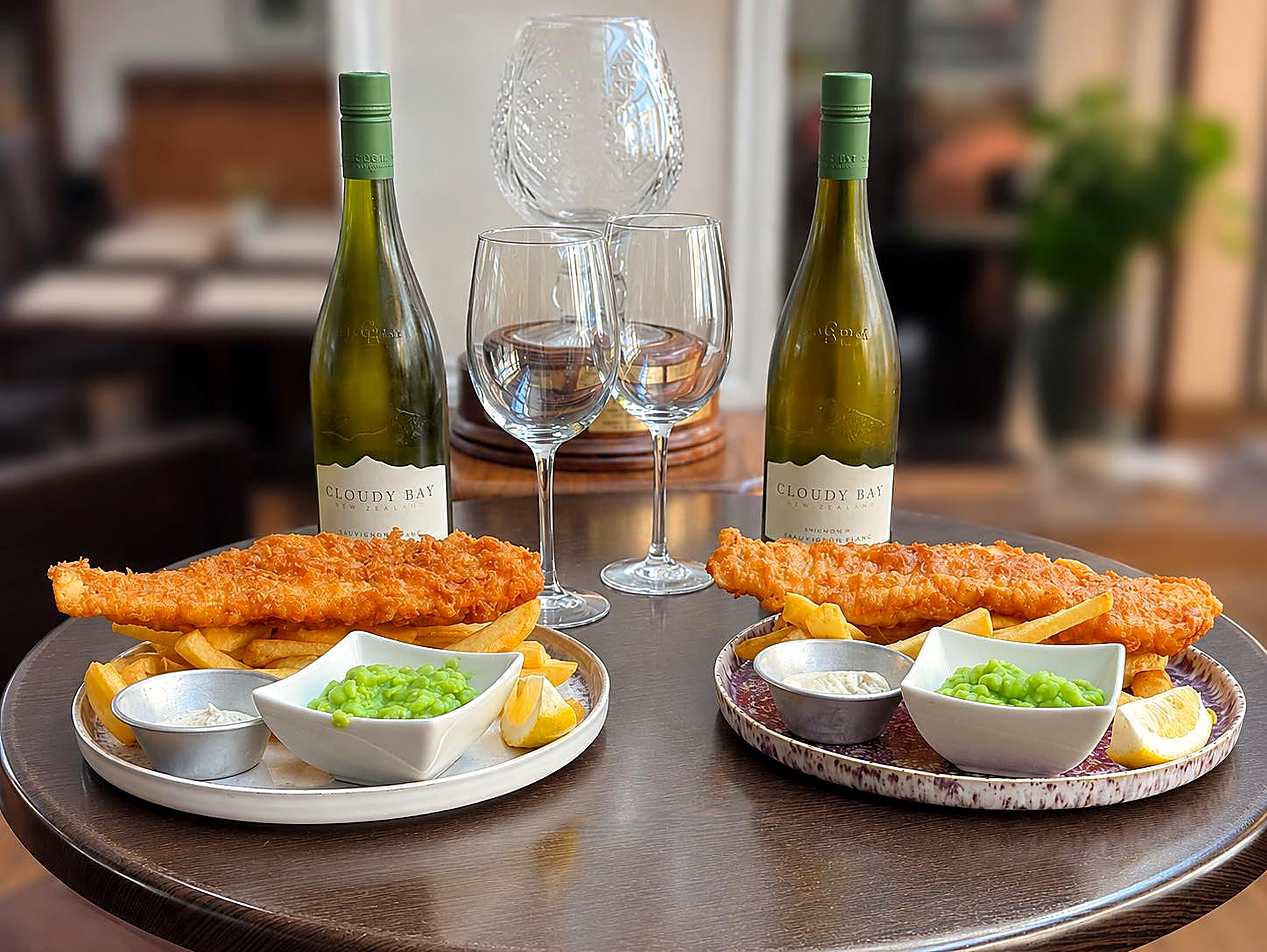 Beer-battered fish and chips with mushy peas and white wine